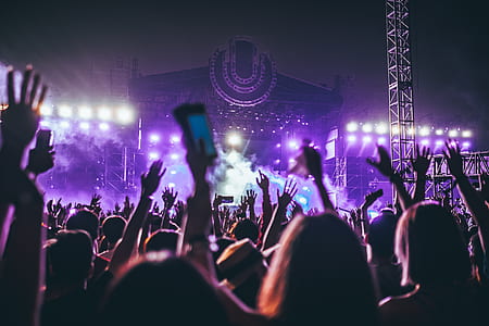 crowd of people facing stage with smoke during nighttime thumbnail