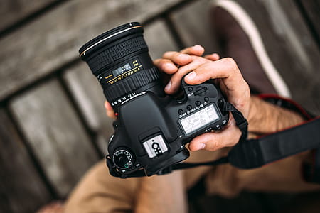 Photographer holding a DSLR camera thumbnail