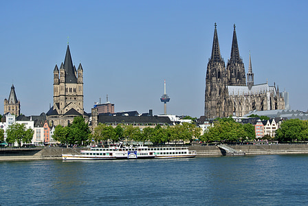 white ship beside brown and grey building at daytime thumbnail