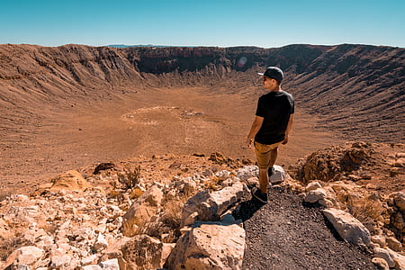 man standing on cliff rock thumbnail