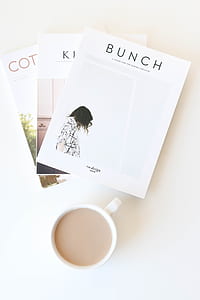 Bunch book beside coffee mug flatlane photograph thumbnail