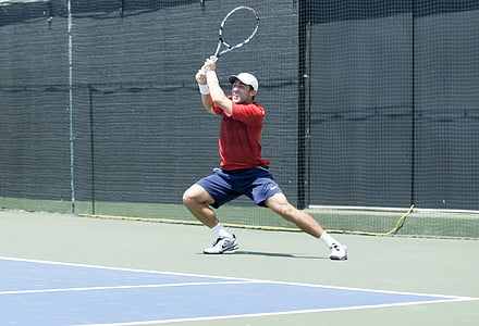man playing tennis on tennis court thumbnail