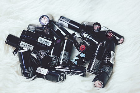 cosmetic bottles on white fur textile thumbnail