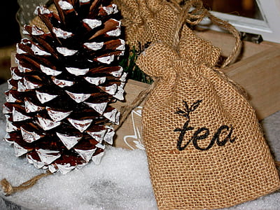 pine cone beside tea-printed bags thumbnail