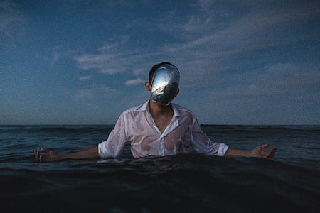 half-immerse man wearing helmet under cloudy sky thumbnail