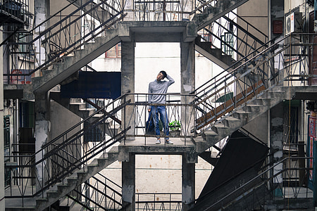 man standing on second floor of building thumbnail