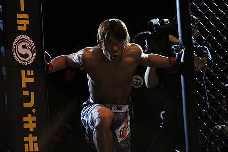 man entering and holding cage thumbnail