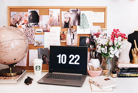 laptop displaying 10 22 near flowers in vases thumbnail