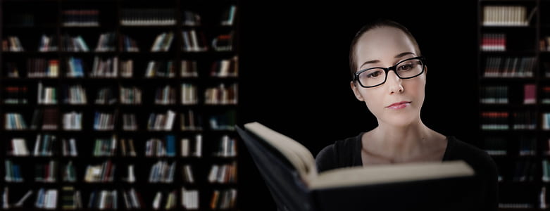 silhouette photography of woman reading book thumbnail