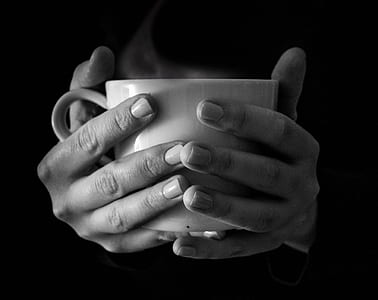 grayscale photo of person holding mug thumbnail