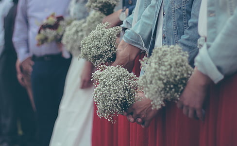 selective focus photography of people holding bouquet of floweres thumbnail