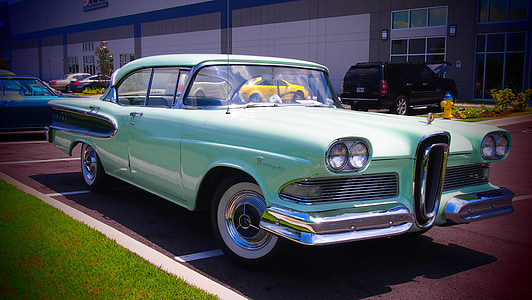 classic light-green sedan on road thumbnail