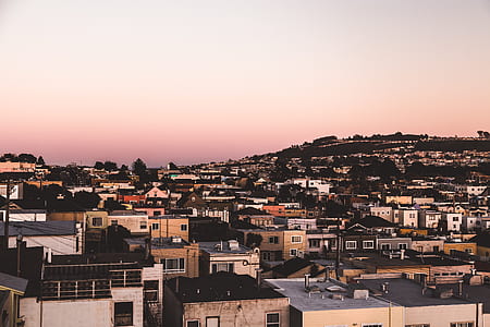 aerial view of buildings under orange and blue sky thumbnail