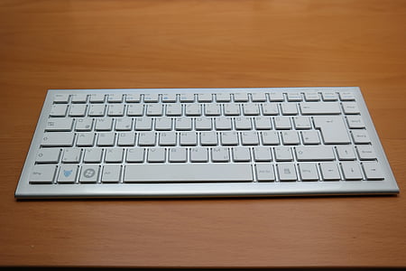 gray wireless computer keyboard on table thumbnail