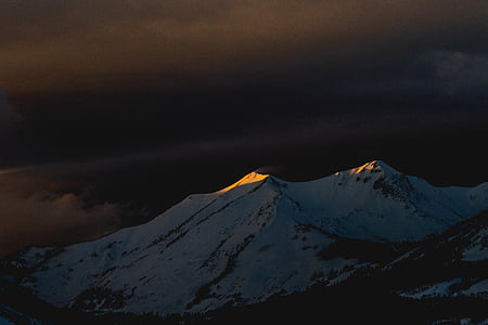 worms eye view of mountain under cloudy sky thumbnail