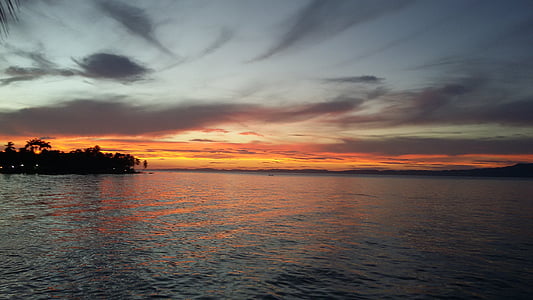 silhouette photo of island near body of wa thumbnail