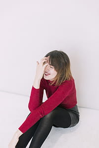 Woman Sitting on the Floor With Left on Her Knees and the Right Hand in Her Face thumbnail