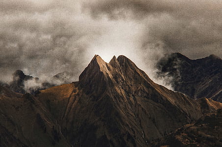 brown mountain surrounded by clouds photo thumbnail