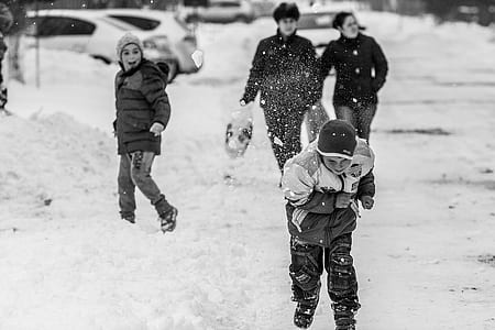grayscale photography of boy running while snowy time thumbnail
