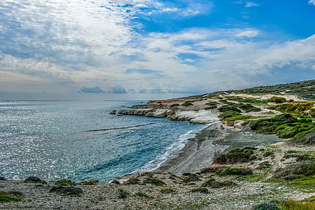 landscape photography of a rock formation near body of water thumbnail