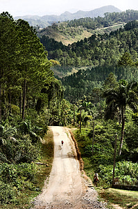 person walking on mountain road at daytime thumbnail
