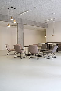 gray padded chair inside white painted wall thumbnail