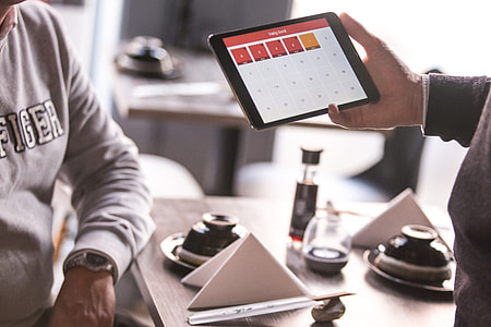 person holding black tablet computer thumbnail