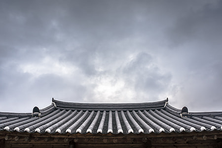 gray roof shingles under cloudy sky during daytime thumbnail