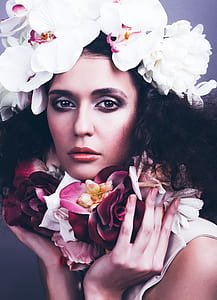 woman wearing white moth orchid flowers hat closeup photo thumbnail
