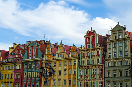 yellow and green concrete buildings under blue sky during daytime thumbnail