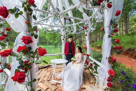man standing beside sitting woman thumbnail