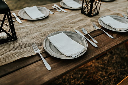 white paper towel on gray plate with gray cutlery set beside thumbnail