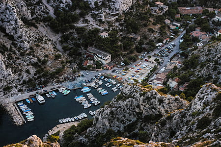 boats on body of water near rock mountain thumbnail