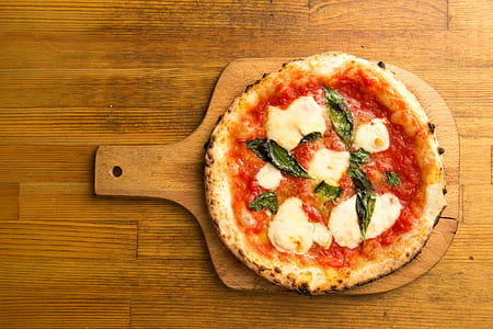 pizza on brown wooden board thumbnail