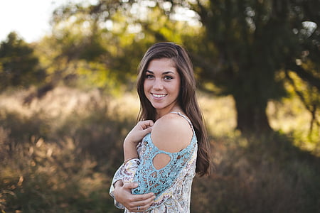 standing woman wearing pink and white floral cold-shoulder top thumbnail