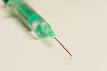 selective focus photography of green syringe thumbnail