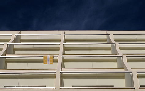 low-angle photography of white concrete building thumbnail