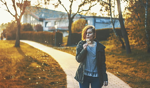 woman blowing on white dandelion thumbnail