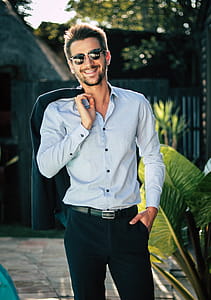 Man in White Dress Shirt Holding Suit Jacket thumbnail