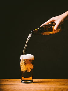 person holding amber glass bottle thumbnail