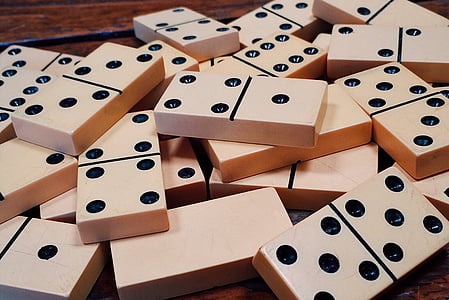 white domino pieces on brown wooden surface thumbnail