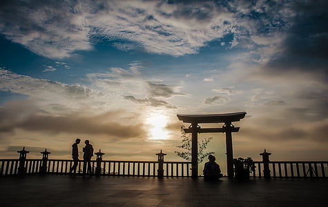 two person standing near railings under cloudy sky thumbnail