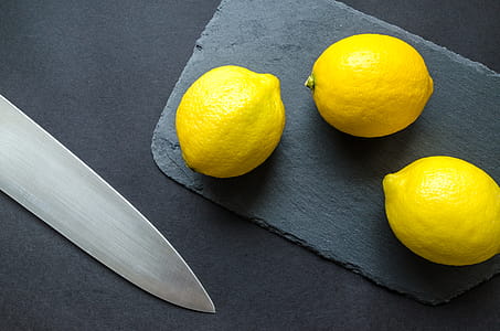 Photo of Three Lemons on Chopping Board Near Knife thumbnail