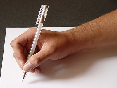 person holding pen writing on white printing paper thumbnail