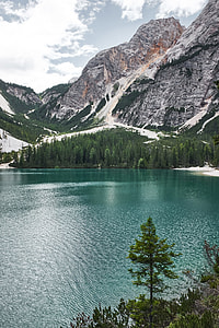 body of water beside mountain thumbnail