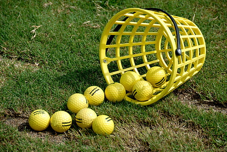 yellow golf balls on ground at daytime thumbnail