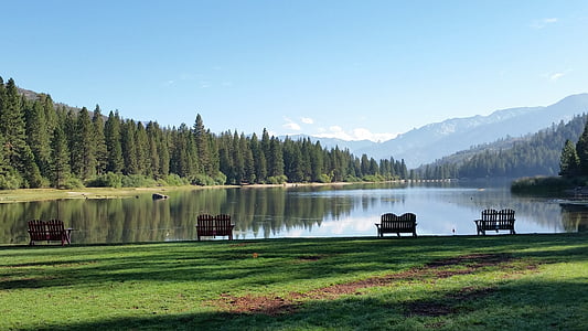 five vacant benches facing body of water thumbnail