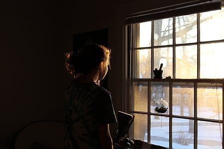 girl in front window under sunrise thumbnail