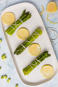 four sliced lemons and three bundle of asparagus thumbnail