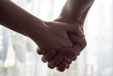 selective focus photography of man and woman holding each other's hands thumbnail